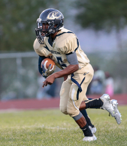 Cheyenne senior Corwin Bush (6), left, runs the ball while being paced by teammate Cheyenne ...