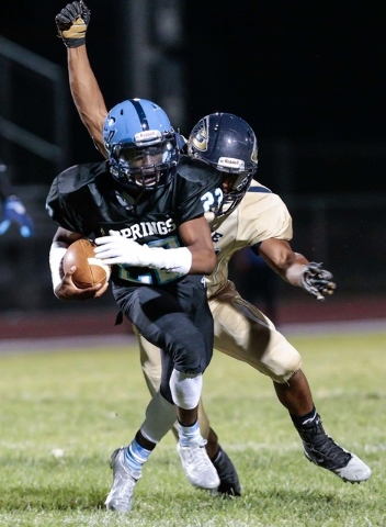 Canyon Springs sophomore Jayvion Pugh (22) attempts to outrun Cheyenne senior Cajuin Jackson ...