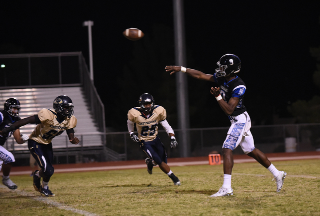 Desert Pines Randal Grimes (9) throws the ball against the Cheyenne defense during their foo ...