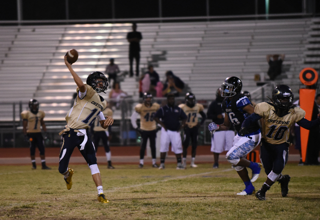 Cheyenne’s Matthew LaBonte (12) throws the ball against Desert Pines defense during th ...