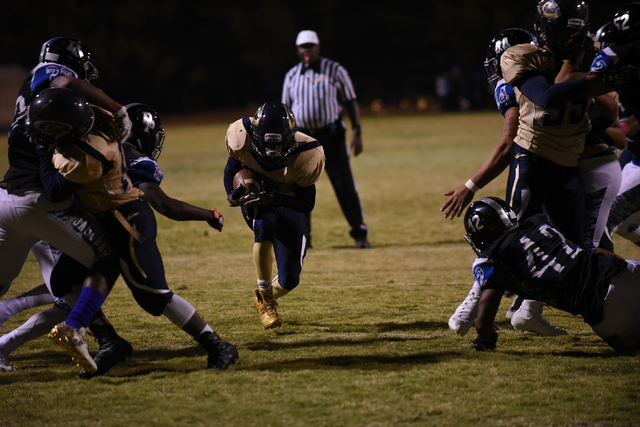 Cheyenne’s Corwin Bush (6) runs the ball against Desert Pines defense during their foo ...