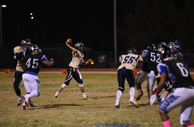 Cheyenne’s Matthew LaBonte (12) throws the ball against Desert Pines defense during th ...