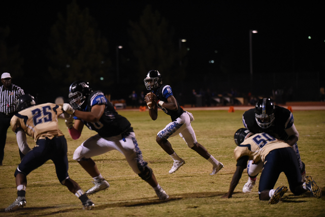 Desert Pines Randal Grimes (9) runs the ball against the Cheyenne defense during their footb ...