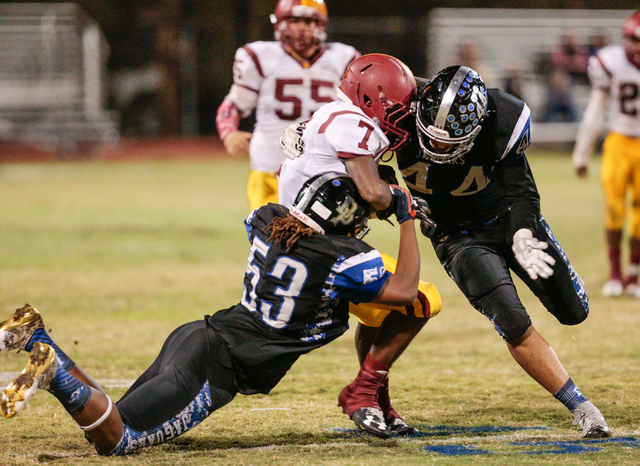 Desert Pines junior Lorenzo Brown (53) and Desert Pines senior Monquel Glasow (44) put the s ...