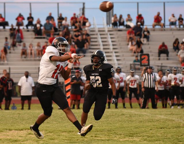 Las Vegas high’s Zach Matlock (12), left, throws a pass against Palo Verde’s Hun ...