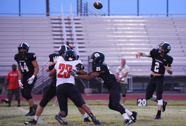 Palo Verde’s Jonathan Schofield (2), right, throws a pass against Las Vegas High Schoo ...