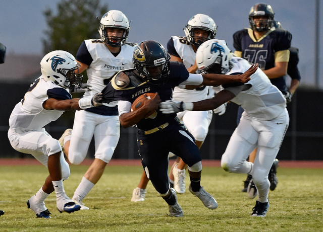 Cheyenne’s Derionte Green carries the ball against the Foothill defense during a high ...