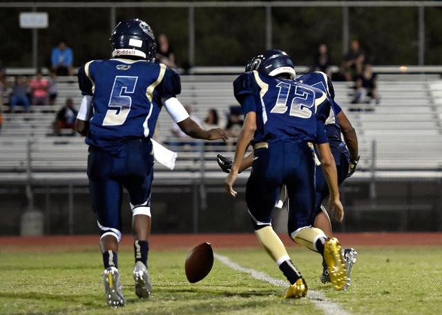 Cheyenne’s Derionte Green (5) and quarterback Matthew LaBonte race to grab a fumble du ...