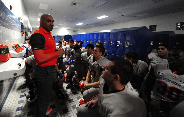 Bishop Gorman head coach Kenny Sanchez addresses his team before the start of their prep foo ...