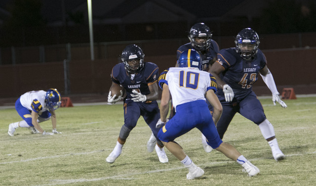 Legacy’s Lamondrel Edmond Jr., second left, runs for a touchdown against Moapa Valley ...