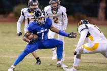 Desert Pines senior Tony Fields (1) attempts to maneuver around Pahrump Valley senior Daniel ...