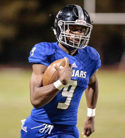 Desert Pines senior Randal Grimes (9) runs the ball during a football matchup against the Pa ...