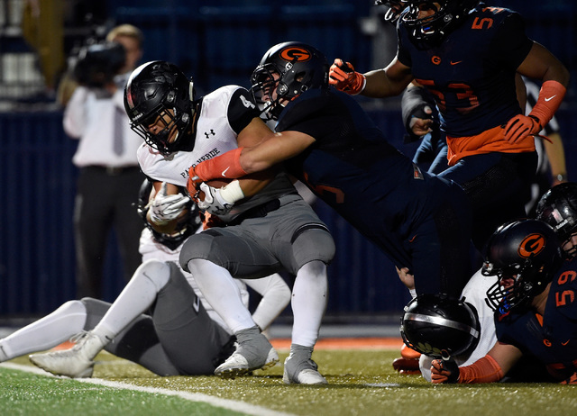 Palo Verde’s Bobby Webster (4) is stopped by Bishop Gorman defense during the first ha ...