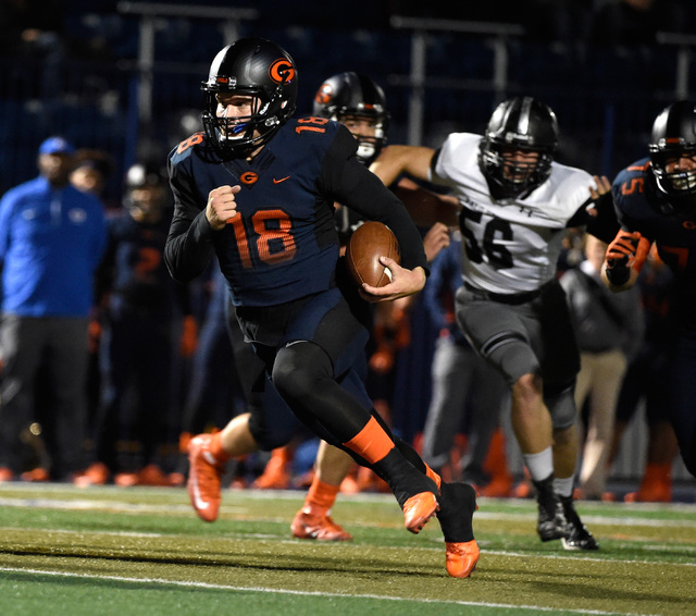 Bishop Gorman quarterback Tate Martell runs with the ball against Palo Verde during the firs ...