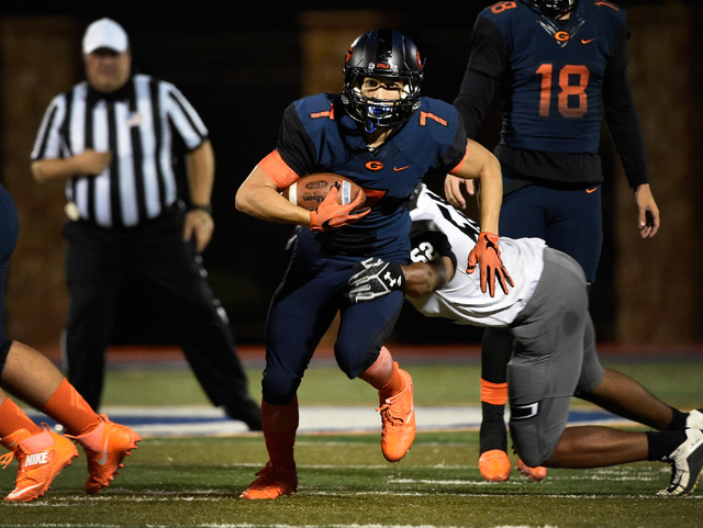 Bishop Gorman’s Biaggio Ali Walsh (7) carries the ball against Palo Verde during the f ...