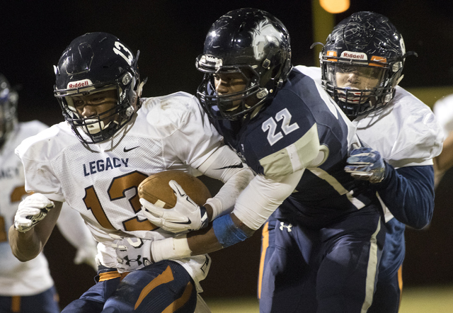 Marcellous McCoy (13) runs the ball against Aubrey Nellems (22) during a Legacy High School ...