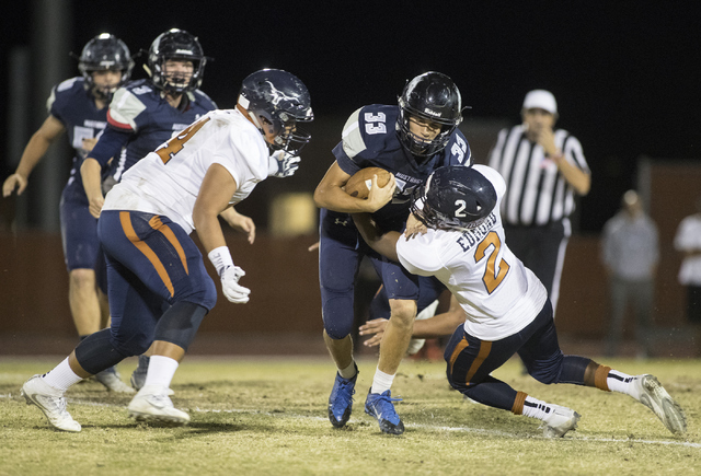 Quarterback Kody Presser (33) runs the ball through Legacy defenders DeAndre Caruthers (4) a ...