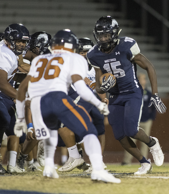 Malik Lindsey (15) advances the ball during a Legacy High School Shadow Ridge High School ga ...