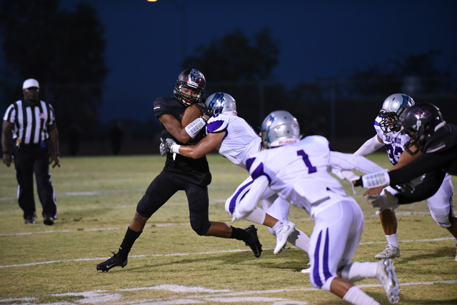 Desert Oasis Jason Sanders (9) is tackled by Silverado’s Pekelo Solomon (8) during the ...