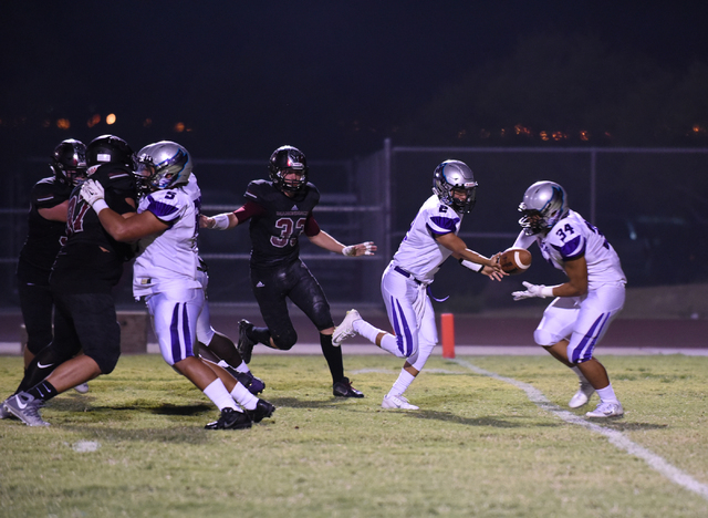 Silverado’s Christian Baltodano (2) hands the ball to teammate Keikiokalani Misipeka ( ...