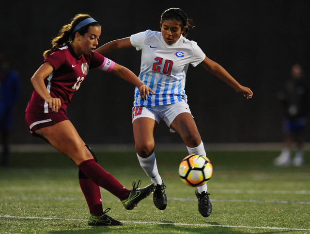 Desert Oasis midfielder Gabriella Nevinger passes the ball in front of Bishop Gorman midfiel ...