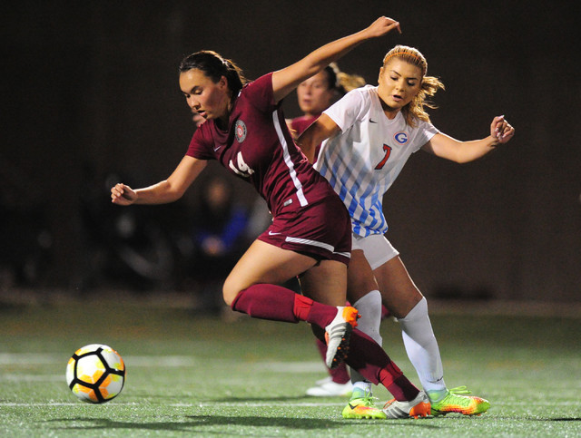 Desert Oasis forward Miah Strellnauer (14) and Jensen Garcia (7) battle for the ball during ...