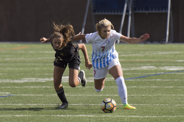 Bishop Gorman’s Jensen Garcia (7) and Faith Lutheran’s Madison Sonerholm (8) run ...