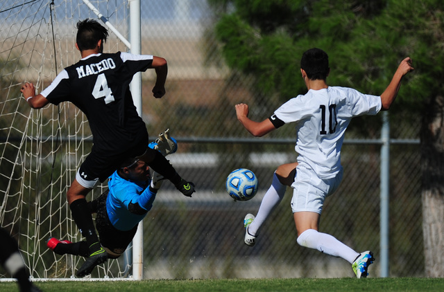 Las Vegas goalkeeper Chris Sosa makes a diving save off of Coronado striker Preston Judd in ...