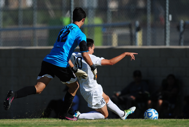 Coronado striker Preston Judd (10) scores a goal in front of Las Vegas goalkeeper Mason Essa ...