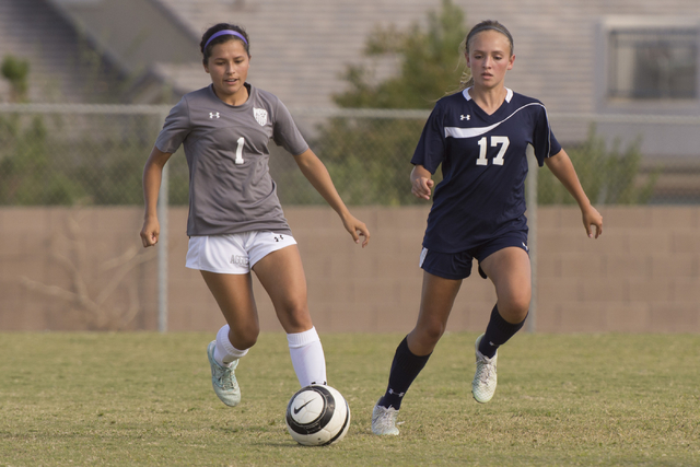 Centennial’s Katelyn Levoyer (17) and Arbor View’s Sierra Vicente (1) fight for ...