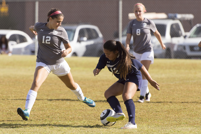 Centennial’s McKenna Estrellado (12) fights for the ball with Arbor View’s Ashle ...