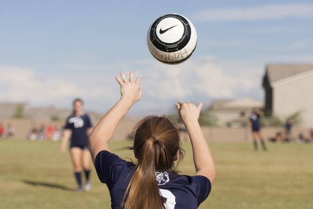 Centennial’s Brooke Hawley (9) throws the ball in during a girls soccer game at Arbor ...