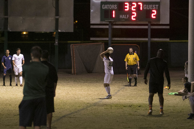 Green Valley’s Elyjah Deleon (10) throws in from the sidelines against Foothill playe ...