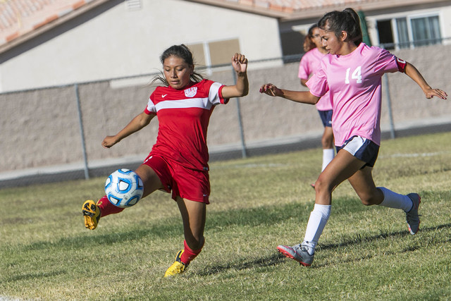 Western’s Vanessa Margarito (8) tries to keep the ball in bounds as she is chased by C ...