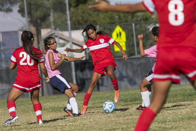 Western’s Geraldi Gomez, center, dribbles by Cheyenne’s Yadira Erives, second le ...