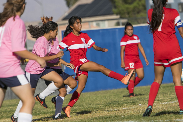 Western’s Geraldi Gomez (18) passes to a teammate as she is pressured by during a vars ...