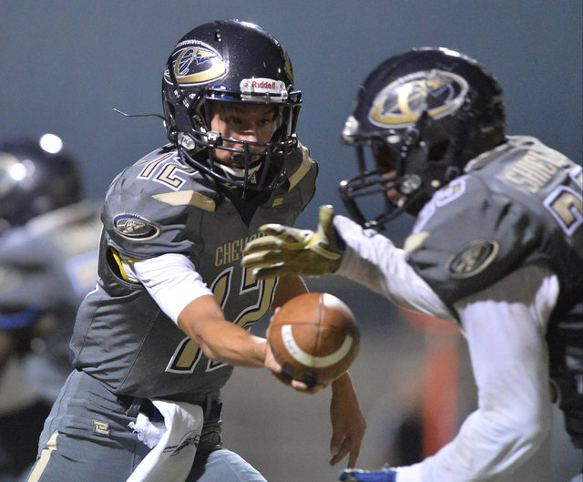 Cheyenne quarterback Matthew LaBonte (12) hands the ball off to Cajun Jackson (25) during th ...