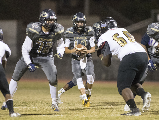 Cheyenne High School’s Matthew LaBonte (12) drops back to pass during a football game ...