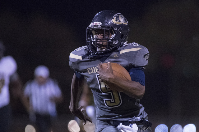 Cheyenne High School’s Deriontae Green (5) runs the ball against Sunrise Mountain High ...