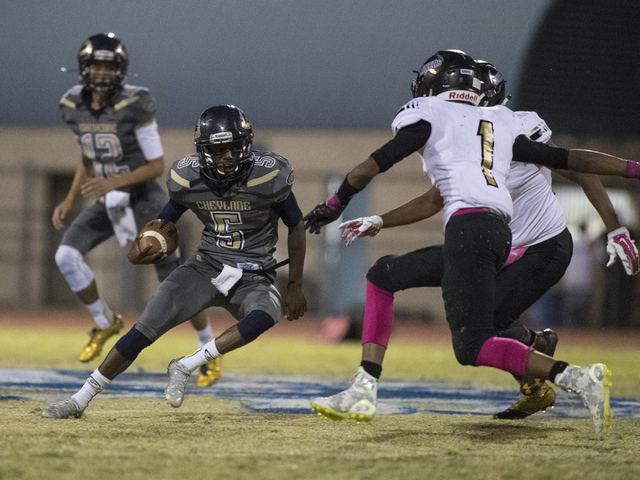 Cheyenne High School’s Deriontae Green (5) runs the ball against Sunrise Mountain High ...