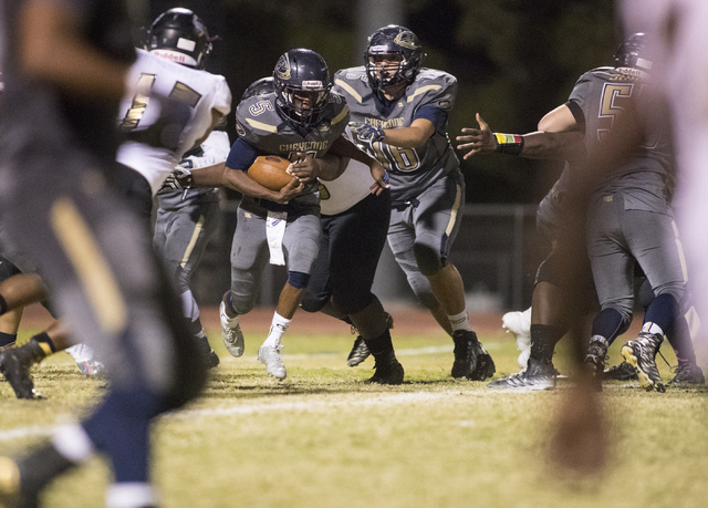 Cheyenne High School’s Deriontae Green (5) runs the ball against Sunrise Mountain High ...