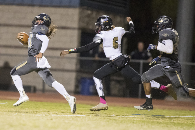 Joseph Kunicki (30) runs the ball against Sunrise Mountain High School during a football gam ...