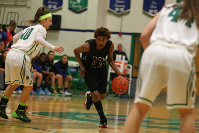 Basic’s Dena Deloney (32) drives past Green Valley’s Maggie Manwarren (10) on Tu ...