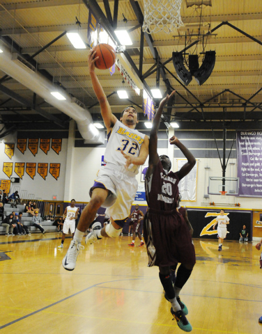 Durango’s Victor Ross (32) leaps for a shot against Cimarron-Memorial’s JaDon Br ...