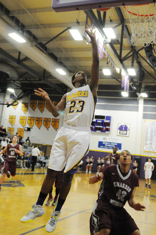 Durango’s Vee Price (23) leaps for a shot over Cimarron-Memorial’s Royce Hightow ...