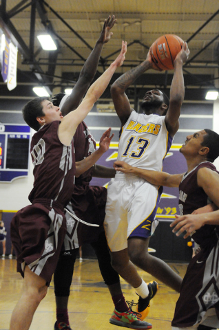 Durango’s Darryl Gaynor (13) takes a jump shot over the Cimarron-Memorial’s defe ...