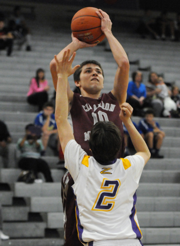 Cimarron-Memorial’s Austin Garrison (10) takes a shot over Durango’s Alex Tarkan ...