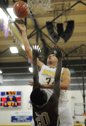 Durango’s Alex Arias (34) leaps for a shot against Cimarron-Memorial’s JaDon Bro ...