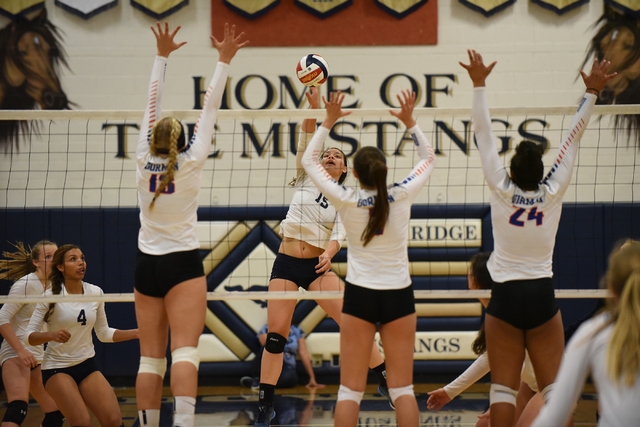 Shadow Ridge’s Whittnee Nihipali (15), center, spikes the ball against Bishop Gorman d ...