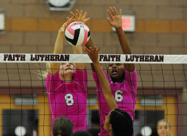 Faith Lutheran’s Bryanna Neagle (8) and Sydney Washington (6) block the ball against P ...